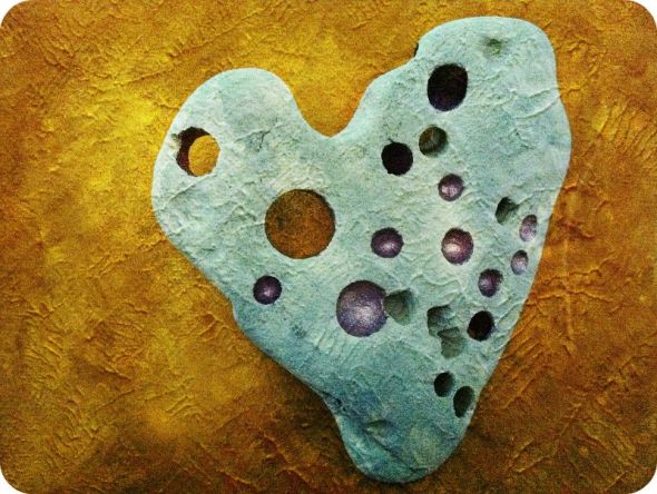 Healing heart stone, "Love Heals" digitally altered image of hand-painted stone.